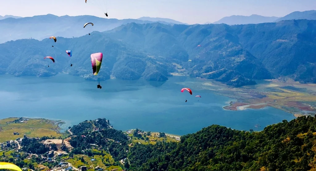 Paragliding in Pokhara over Phewa Lake with Annapurna mountain range in the background